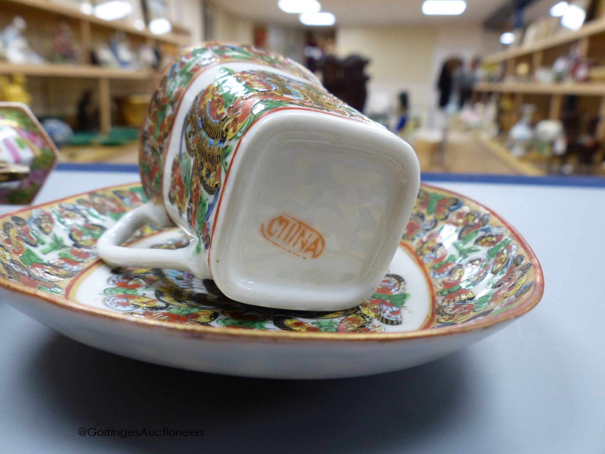 A Chinese famille rose small vase and two cups and saucers